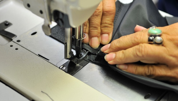 LCI employee’s hands and a sewing machine