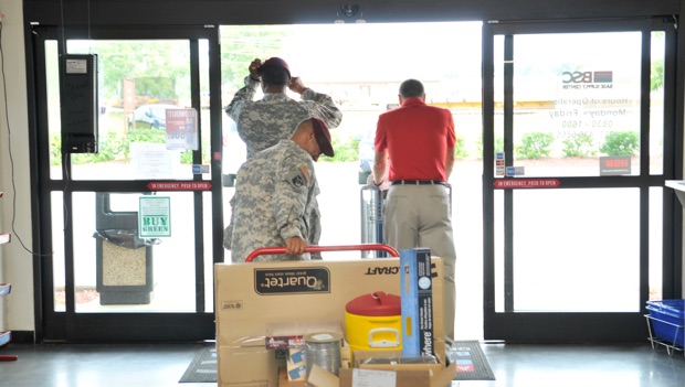 military personnel leaving an LCI base supply center with the gear and materials they’ve purchased